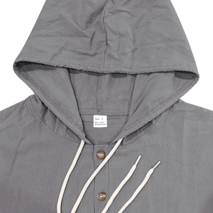Detail of grey linen shirt collar with S size tag and 95% linen material information