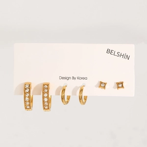 Detail view of gold-plated earring set including pavé hoops and star studs