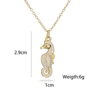 Detail of 18K gold plated seahorse pendant necklace with white enamel and size specs