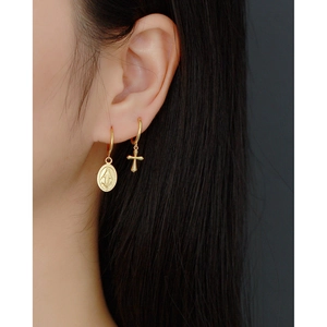 Close-up of gold S925 silver hoop earrings with religious Mary and cross pendants