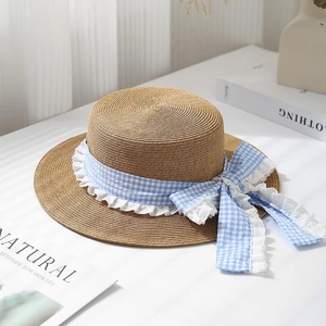 Women's summer straw boater hat with a blue gingham ribbon bow and lace trim detail