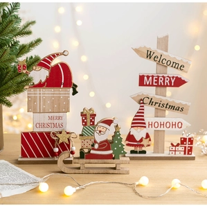 Detail of wooden Christmas table sign with Santa and Merry Christmas lettering