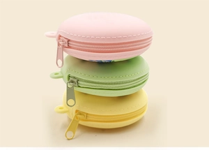 Vertical stack of macaron-shaped silicone coin purses with zippers in pastel colors