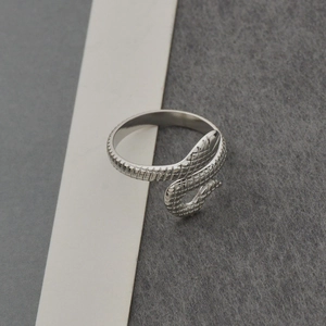 Detailed view of snake-shaped titanium steel ring with intricate scale textures