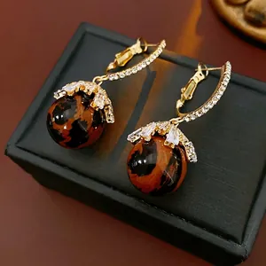 Leopard print ball drop earrings with gold hoops and shimmering zircon accents