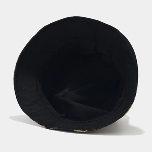 Detail of outdoor camouflage bucket hat featuring a solid black lining and durable stitching