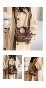 Detail of dark brown ruched cloud bag showing metallic chain and soft leather texture