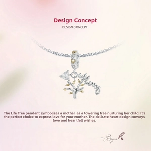 Detailed view of silver tree of life charm with gold leaves and Mom engraving