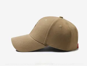 Close-up of khaki baseball cap with S embroidery and red side woven brand label