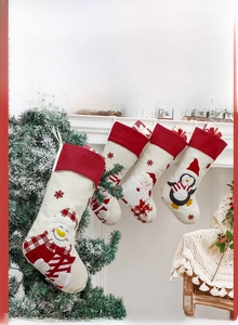Detailed view of Christmas stockings with Santa and elk patterns on a festive fireplace