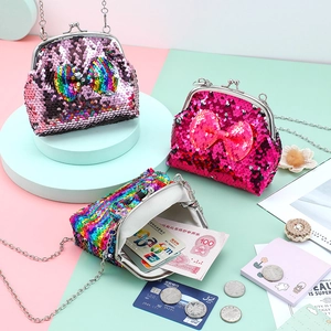 Close-up of sequin coin purses with metal clasps and chains on a colorful background