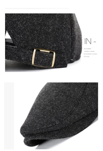 Detail view of the bronze metal buckle and wool texture on a dark grey newsboy hat