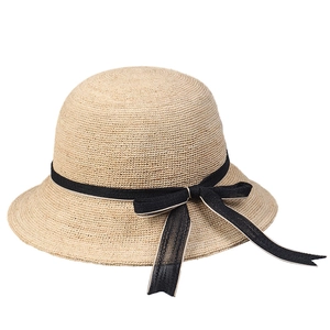 Elegant beige raffia sun hat with black bow ribbon and dome brim for summer vacations