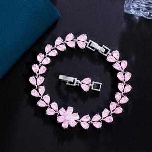 Detailed macro view of pink zircon flower bracelet with silver plated leaf settings