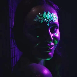 Glow-in-the-dark face jewels for Halloween with green luminous leaf patterns