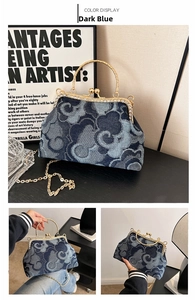 Close-up of dark blue denim kiss-lock bag with cloud pattern and rhinestone accents