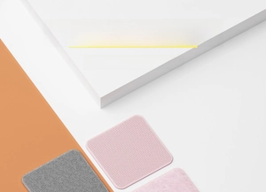 Macro detail of square non-slip sofa cover fixers in pink and gray colors