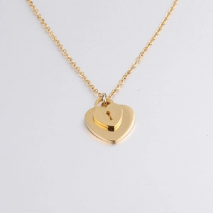 Close-up of golden double heart pendant necklace with keyhole design in stainless steel