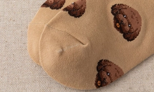 Macro detail of seamless toe stitching and cute brown puppy print on cotton socks
