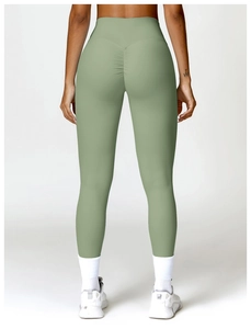 Detail view of high waisted bean green yoga leggings featuring a scrunch butt design