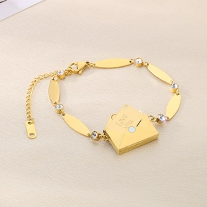Detail of gold envelope pendant with Love You engraving and sparkling crystal accents