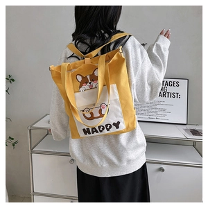 Rear view of a model wearing the yellow Corgi canvas bag as a versatile backpack