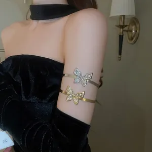 Elegant butterfly upper arm cuff with shimmering crystals in gold and silver finish