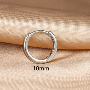 Detailed view of 10mm minimalist silver hoop earring on champagne satin fabric