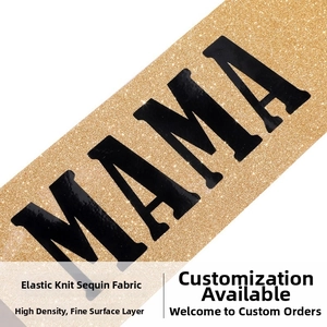 Macro shot of high-density gold glitter elastic fabric with bold black MAMA lettering