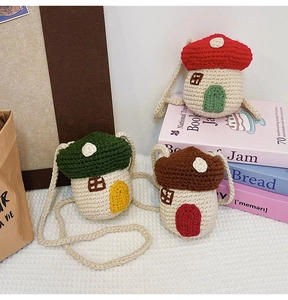 Detail of handcrafted crochet mushroom bags in red, green, and brown roof designs