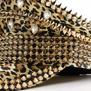 Macro shot of leopard print hat with golden punk studs and crystal rhinestones