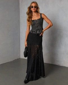 Detail of the high-waisted black lace sheer skirt and vintage tie-up gray denim vest