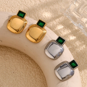 Vintage 18K gold and silver plated square earrings with green zircon on display