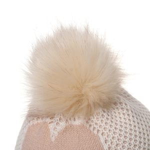 Close-up of pink heart-patterned knit hat featuring a large fluffy faux fur pompom detail