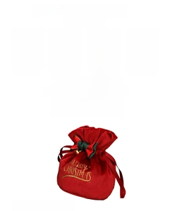 Macro shot of red velvet Christmas gift bag with gold Merry Christmas embroidery and ribbon
