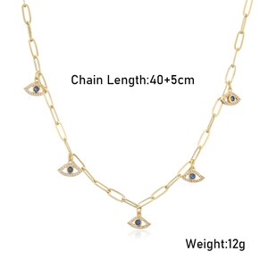 Detail view of gold-plated paperclip chain necklace with blue evil eye charms and dimensions