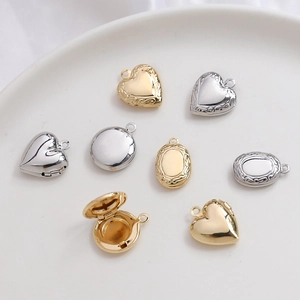 Various 14k gold and silver heart, oval, and round locket pendants in a ceramic dish