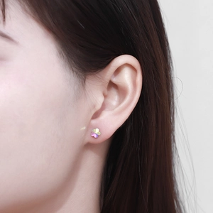 Close-up of a gradient iridescent five-petal flower sterling silver stud earring on a model