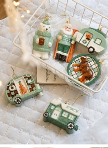 Detailed view of sage green Christmas resin pendants with golden cords in a festive setting
