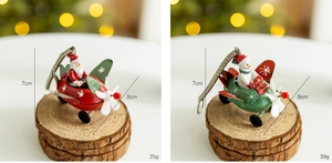 Detailed view of metal Christmas plane ornaments with Santa and snowman motifs