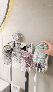 Detail of suction cup wall mount toothbrush holder with four ripple textured glass cups