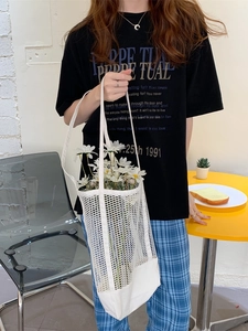 White mesh tote bag with canvas base and handles, featuring a modern hollow-out design