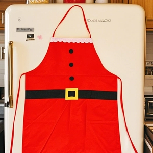Classic Santa Claus apron with black belt pattern and white wavy trim on a white background