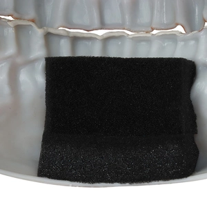 Macro detail of black protective foam padding inside the white plastic skull mask