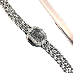 Elegant silver quartz watch for women with crystal bezel and mesh band on white background