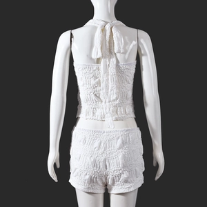 Rear view of white textured bubble fabric two-piece set with halter top and shorts