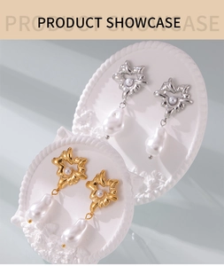 Detail of star-shaped gold and silver earrings with baroque pearls on white pedestal