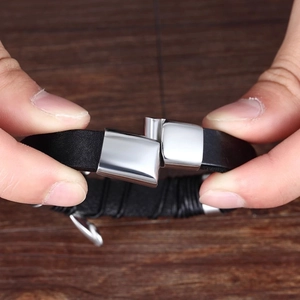 Close-up of a double braided leather bracelet featuring a silver magnetic steel clasp