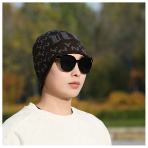 Outdoor portrait of a men's winter knit beanie with NY jacquard pattern and fleece lining