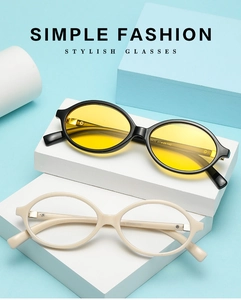 Detail of oval sunglasses in black and beige frames with high-quality metal hinges